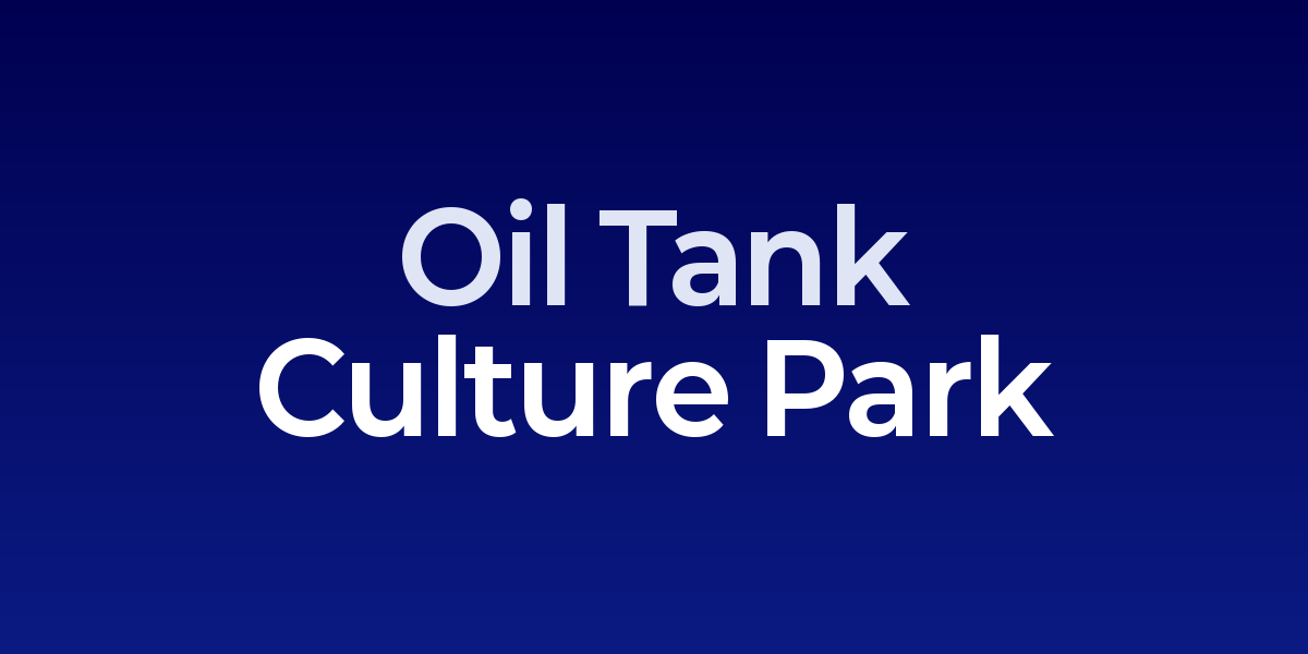 Large circular oil tanks converted into cultural spaces with people walking through industrial courtyards